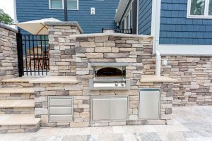 Custom outdoor kitchen with pizza oven in Rehoboth Beach, Delaware.