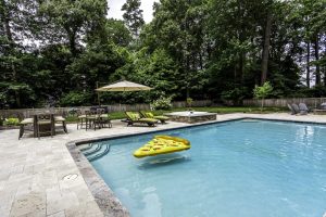 Concrete pool with beige travertine
