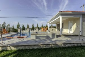 outdoor living area with pool by ashton pools by design