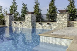 outdoor swimming pool with water features by ashton pools by design