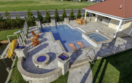 Geometric pool with firepit, spa, and pool house