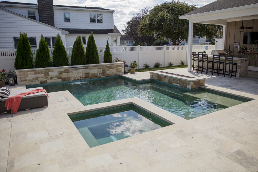 Courtyard style pool, year round spa, and outdoor kitchen