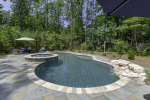 Freeform pool, rock waterfall and year round spa