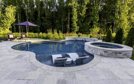 Freeform pool with waterwall, seperate spa, tanning ledge