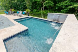 corner swimming pool with waterfall features by Ashton Pools By Design