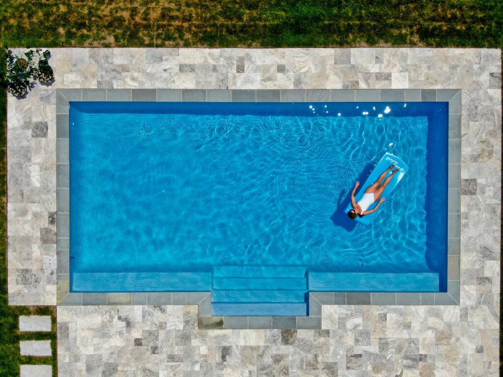 Fiberglass pool with woman on a float